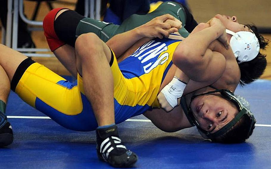 St. Mary&#39;s International&#39;s JP Kwak puts a reverse cradle on Kubasaki&#39;s Kevin Orr during Tuesday&#39;s 129-pound quarterfinal bout in the 34th Far East High School Wrestling Tournament at Super Gym, Camp Humphreys, South Korea. Kwak pinned Orr in 2 minutes, 57 seconds.