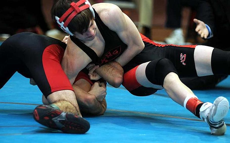 Nile C. Kinnick&#39;s Marcus Boehler locks in a double-chicken wing hold on E.J. King&#39;s Ernesto Garcia during Tuesday&#39;s 122-pound quarterfinal bout in the 34th Far East High School Wrestling Tournament at Super Gym, Camp Humphreys, South Korea. Two-time reigning Far East gold medalist Boehler pinned Garcia in 38 seconds.