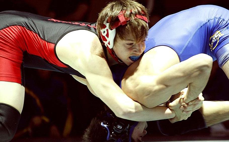 Three-time Far East gold medalist Marcus Boehler of Nile C. Kinnick gets the upper hand on St. Mary's Kelly Langley during Wednesday's 122-pound gold-medal bout in the 34th Far East High School Wrestling Tournament at Camp Humphreys, South Korea. Boehler decisioned Langley 2-0 (4-0, 7-0).