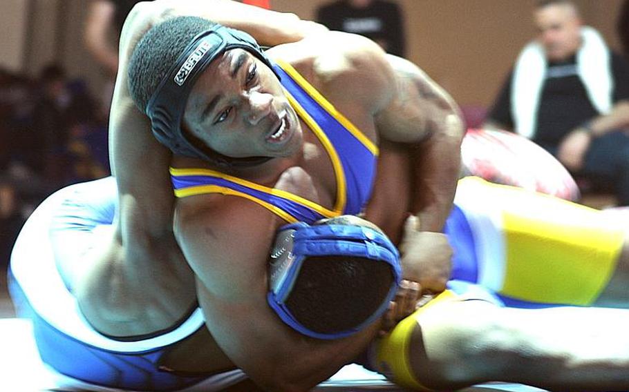 Two-time Far East gold medalist Devin Day of Yokota catches Seoul American's Eric Bush with a head-in-arm hold during Wednesday's 135-pound gold-medal bout in the 34th Far East High School Wrestling Tournament at Camp Humphreys, South Korea. Day pinned Bush in 3 minutes, 18 seconds.
