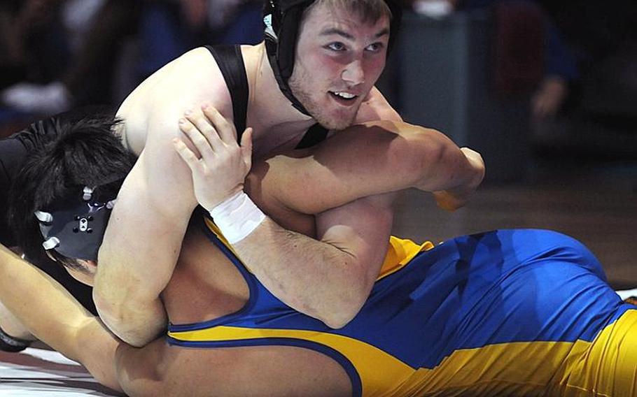 Three-time Far East gold medalist Michael Spencer wrenches the shoulders of St. Mary's Jeffrey Koo toward the mat during Wednesday's 168-pound gold-medal bout in the 34th Far East High School Wrestling Tournament at Camp Humphreys, South Korea. Spencer decisioned Koo 2-0 (7-0, 6-0).