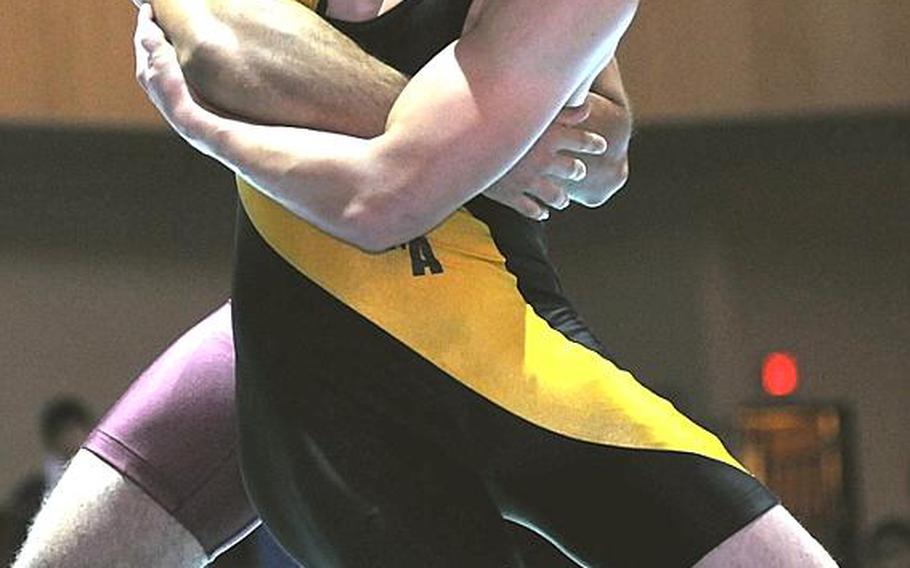 Kadena's Cory Peckins tries to leg-trip Christopher Aguon of Guam's Father Duenas Memorial School during Wednesday's 158-pound gold-medal bout in the 34th Far East High School Wrestling Tournament at Camp Humphreys, South Korea. Peckins decisioned Aguon 2-1 (7-1, 0-1, 3-2).