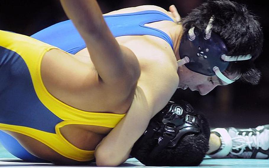Soma Yoshida of St. Mary's International wrenches the shoulders of Guam High's Bryan Taijeron toward the mat during Wednesday's 115-pound gold-medal bout in the 34th Far East High School Wrestling Tournament at Camp Humphreys, South Korea. Yoshida pinned Taijeron in 2:39 and the Titans won their seventh Far East tournament team title.