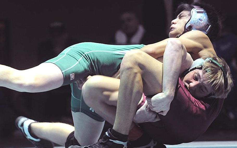 Kubasaki's Jon Goddard and Father Duenas Memorial's Bruce Julian try to gain the advantage during Wednesday's 141-pound gold-medal bout in the 34th Far East High School Wrestling Tournament at Camp Humphreys, South Korea. Goddard decisioned Julian 2-0 (7-0, 5-3).
