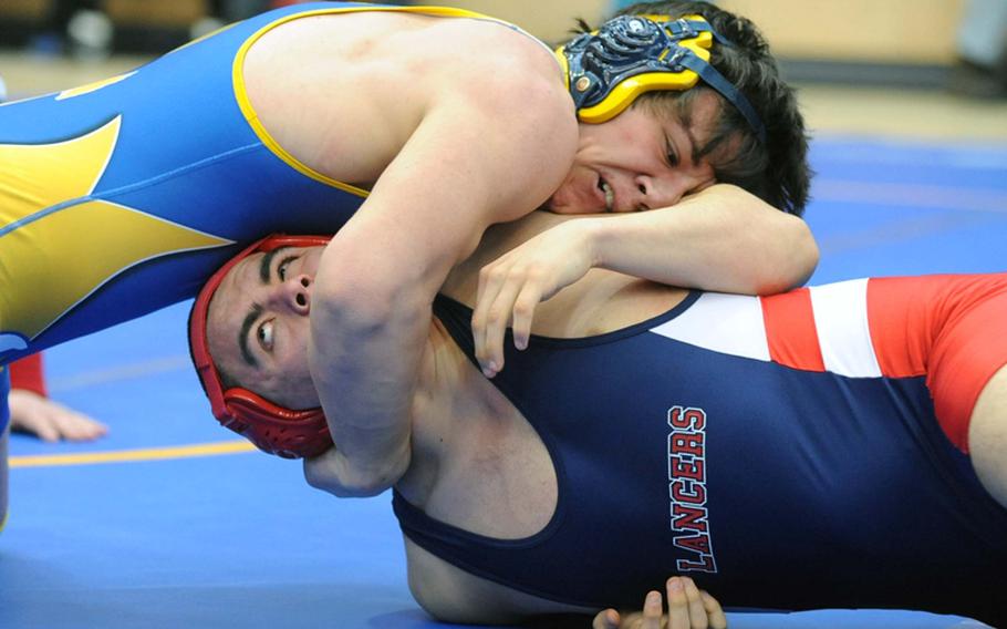 Wiesbaden's Erik Stouter, top, has Lakenheath's Shae Emerton in a bad position in their 215-pound match at the DODDS Europe wrestling championships in Wiesbaden, on Friday. Emerton was able to turn the tables on Stouter and win the first-round match.