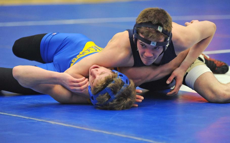 In a 135-pound, first-round match at the DODDS Europe wrestling finals, Chase Berryhill of Sigonella, left, can't get out of the grasp of Heidelberg's Kyle Swords. The Heidelberg wrestler went on to win the match.