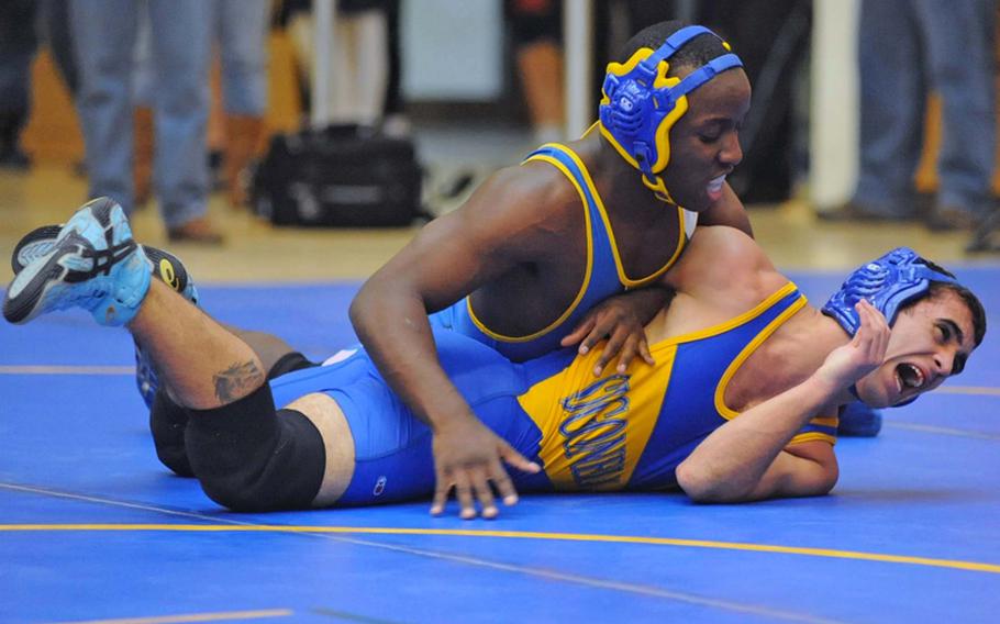 Wiesbaden's Jamichael Wiley, left, tries to turn Sigonella's Marco Summerfield in their 140-pound, first-round match at the DODDS-Europe wrestling championships on Friday. Wiley went on to win.