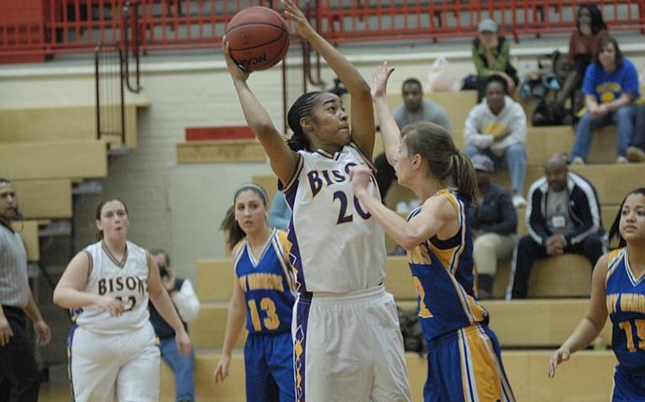 Mannheim junior Kadedra Lea goes up for a shot as Wiesbaden sophomore Meghan Smith defends Friday night at Mannheim's Benjamin Franklin Village Sports Arena. Wiesbaden won, 44-24,  in the final girls basketball regular-season game for Mannheim High School, which is closing.