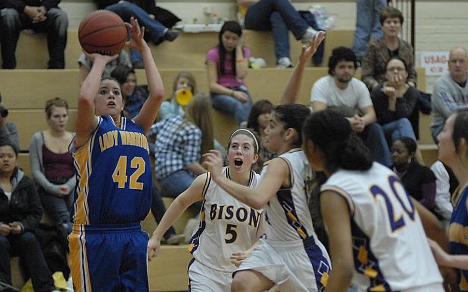 Wiesbaden senior Taylor Dore tries to get off a second-half shot before Mannheim sophomore Grace Gonzalez, center, can block her shot Friday night.  Also pictured are Bison senior Gretchen Crochett (5)  and Mannheim junior Kadedra Lea (20). Wiesbaden won, 44-24, in the final girls basketball regular-season game for Mannheim High School, which is closing.