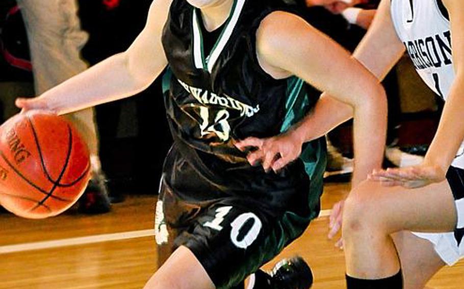 Daegu American&#39;s Sarah Wright (10) drives to the basket around Paulili Park of Morrison Academy during Tuesday&#39;s pool-play game in the Far East High School Girls Division II Basketball Tournament at Warrior Gym, Daegu American School, Camp George, South Korea. Defending champion Daegu routed Morrison 46-30.