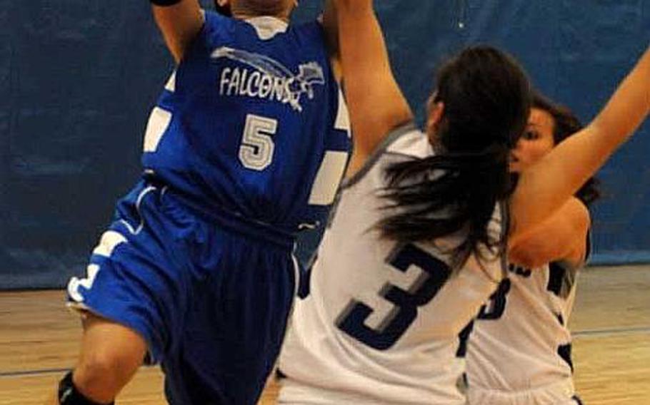 Seoul American&#39;s Liz Gleaves shoots over Mariana (3) and Taylor Crisostomo of Notre Dame during Tuesday&#39;s pool-play game in the Far East High School Girls Division I Basketball Tournament at Charles King Fitness & Sports Center, Naval Base Guam. Seoul American won 81-51.