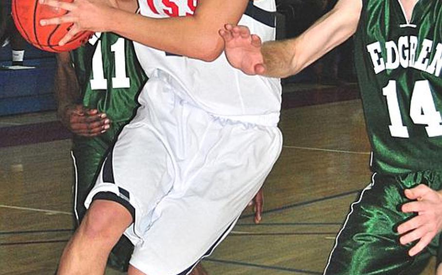 Yongsan International-Seoul&#39;s Anthony Kim takes the ball to the basket against Robert D. Edgren&#39;s Christian Weldon (14) during Tuesday&#39;s pool-play game in the Far East High School Boys Division II Basketball Tournament at Kelly Fitness & Sports Center, Camp Walker, South Korea. Edgren beat YIS-Seoul 54-47.