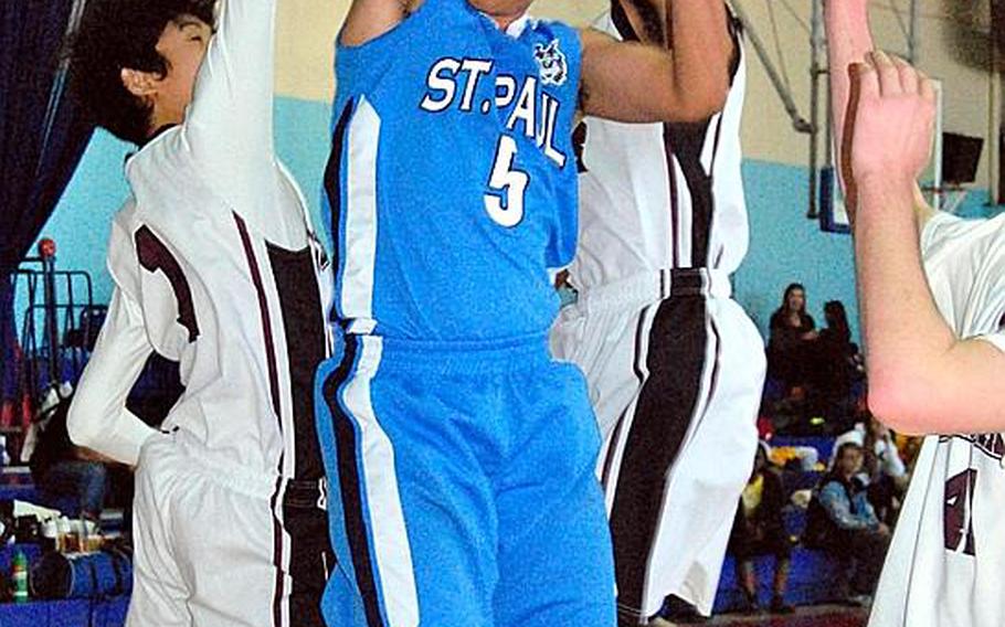 St. Paul Christian&#39;s John Mangonon (5) pulls down a rebound amid three Matthew C. Perry players during Tuesday&#39;s pool-play game in the Far East High School Boys Division II Basketball Tournament at Kelly Fitness & Sports Center, Camp Walker, South Korea. St. Paul beat M.C. Perry 41-28.