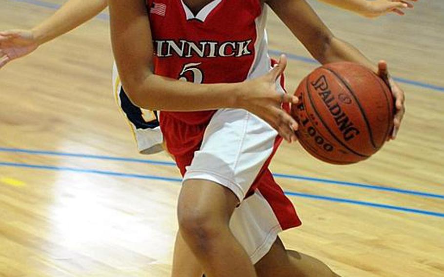 Nile C. Kinnick's Keajah Howard drives to the basket against Guam High during Wednesday's single-elimination playoff game in the Far East High School Girls Division I Basketball Tournament at Charles King Fitness & Sports Center, Naval Base Guam. Kinnick won, 34-17.