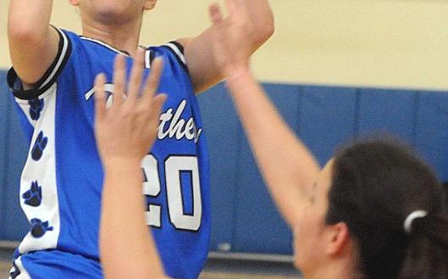 Yokota's Ayanna Thomas puts up a shot over Kyla Chipman of Hong Kong International during Thursday's quarterfinal game in the Far East High School Girls Division I Basketball Tournament at Charles King Fitness & Sports Center, Naval Base Guam. Yokota won, 48-44.