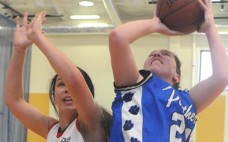 Yokota's Julia Marrin puts up a shot against Kyla Chipman of Hong Kong International during Thursday's quarterfinal game in the Far East High School Girls Division I Basketball Tournament at Charles King Fitness & Sports Center, Naval Base Guam. Yokota won, 48-44.