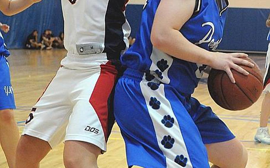 Yokota's Julia Marrin prepares a shot against Kyla Chipman of Hong Kong International during Thursday's quarterfinal game in the Far East High School Girls Division I Basketball Tournament at Charles King Fitness & Sports Center, Naval Base Guam. Yokota won, 48-44.