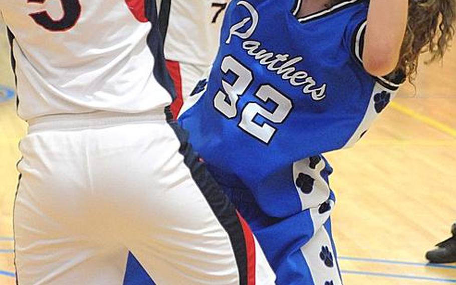 Yokota's Sydney Glover battles for the ball against Kyla Chipman of Hong Kong International during Thursday's quarterfinal game in the Far East High School Girls Division I Basketball Tournament at Charles King Fitness & Sports Center, Naval Base Guam. Yokota won, 48-44.