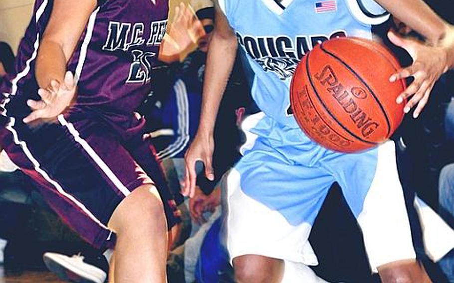 Osan American's Chantal Colmore looks to dribble past Matthew C. Perry's Aliana Alexander during Thursday's knockout bracket game in the Far East High School Girls Division II Basketball Tournament at  Daegu American School, South Korea. Osan won, 55-29.