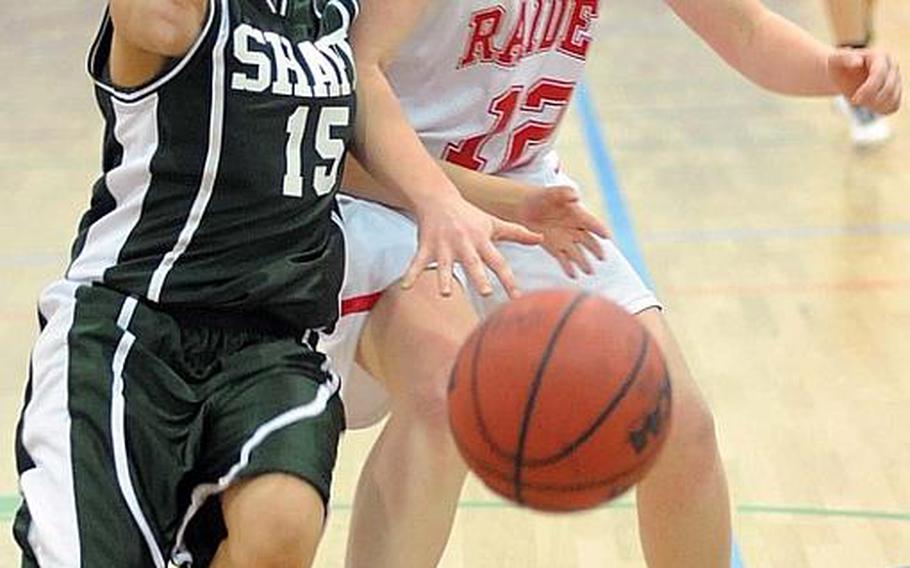 SHAPE's Jamie Gamboa, left, steals the ball from Kaiserslautern's Karah Helm in a Division I game at the DODDS Europe basketball finals in Heidelberg, on Thursday. Kaiserslautern won the game, 40-30.