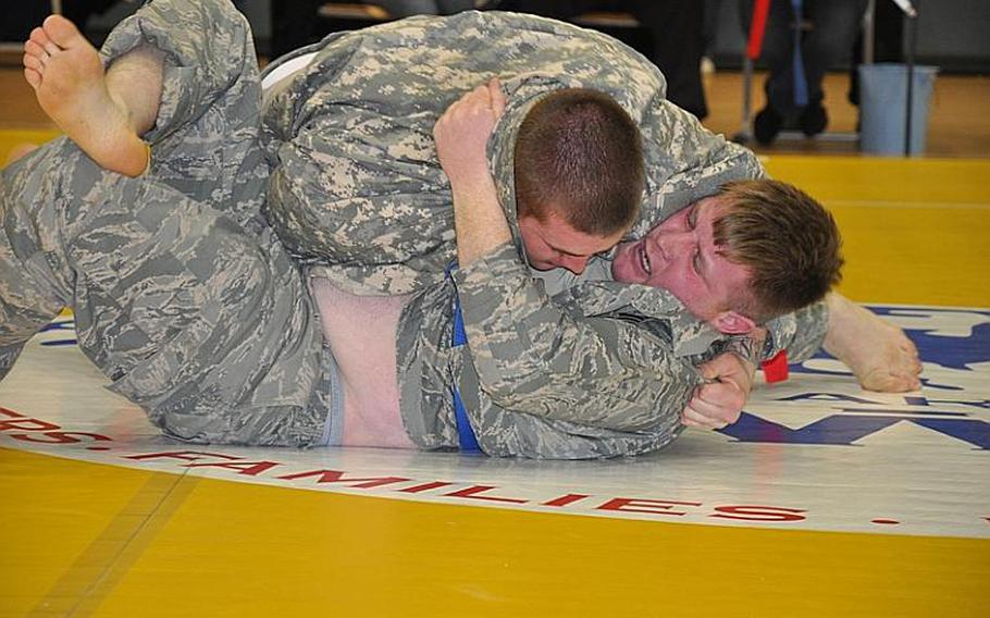Jeffrey Sanderson, bottom, battles Joshua Achor on Friday during the second annual European Forces Combatives Championships in Bamberg, Germany. Achor won the match and finished second in the heavyweight division, while Sanderson finished third.