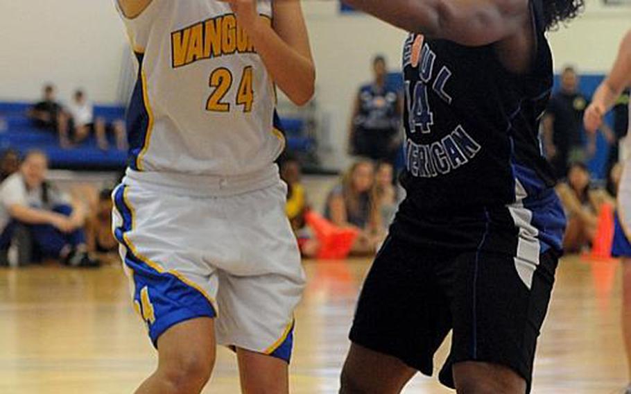 Faith Academy's Kelly Hardeman tries to pass the ball around Seoul American's Destinee Harrison during Saturday's championship game in the Far East High School Girls Division I Basketball Tournament at Charles King Fitness & Sports Center, Naval Base, Guam. Seoul American beat Faith Academy for the second straight year, 47-39.