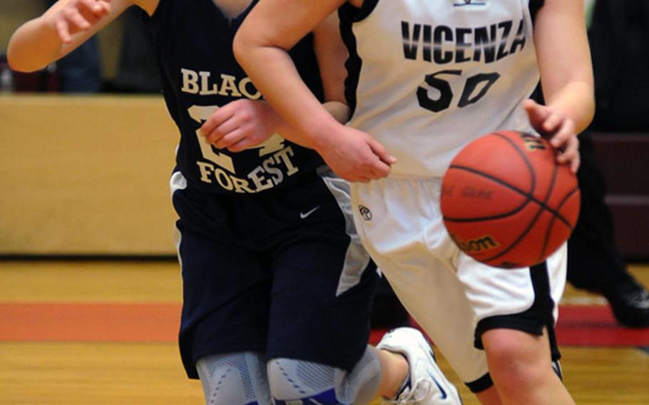 Vicenza's Sella Pauling drives against Black Forest Academy's Natalie Bertrand in the girls Division II title game. Pauling scored the game-winning basket in overtime to give Vicenza a 37-36 win.