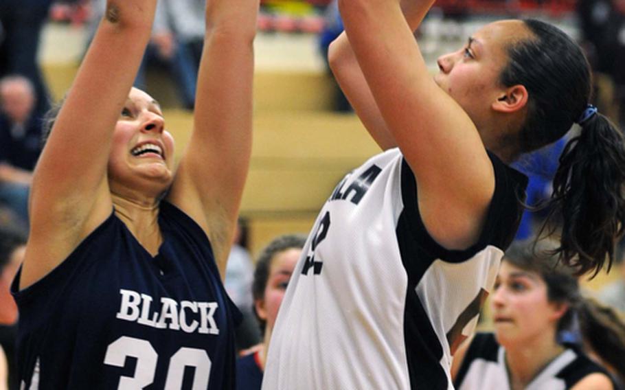 Vicenza's Danielle Ellis, right shoots over Black Forest Academy's Esther Shady in the girls Division II final, won by Vicenza, 37-36, in overtime.