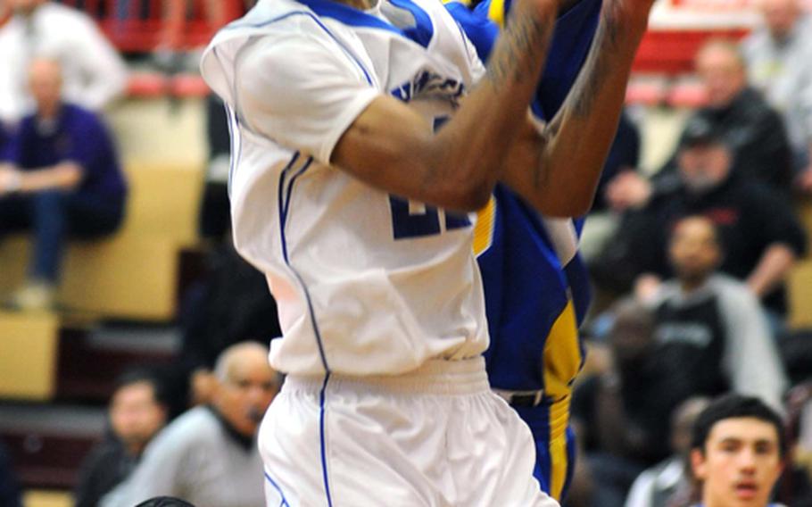 Jamie Tompkins of Hohenfels, left, is fouled by Bamberg's Javonte Knuckles on his way to the basket in the DODDS Europe Division II boys basketball final on Saturday. Hohenfels took the title with a 51-37 win.