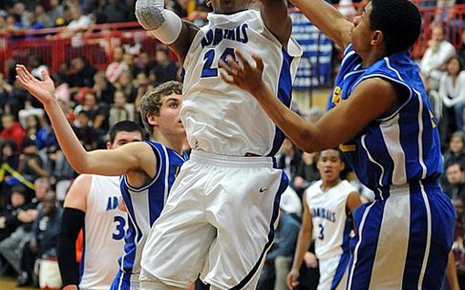 Rota's Tre'von Owens aims for the hoop as Sigonella's Kalil Bowen defends. Rota beat Sigonella, 65-61, to take the DODDS Europe Division III boys basketball title. Owens was named the tourney DIII MVP.