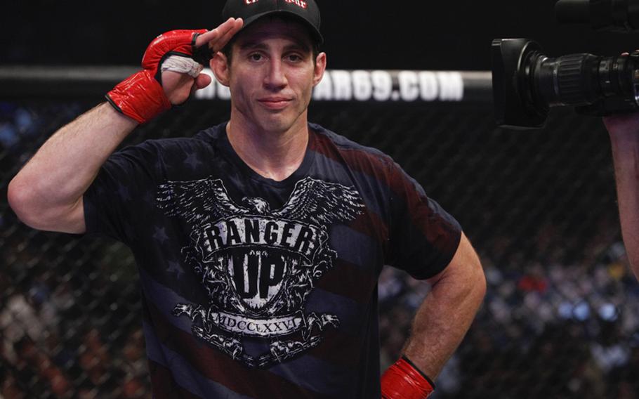 Tim  Kennedy celebrates with a salute after his submission victory over Trevor Prangley in a Mixed Marital Arts bout