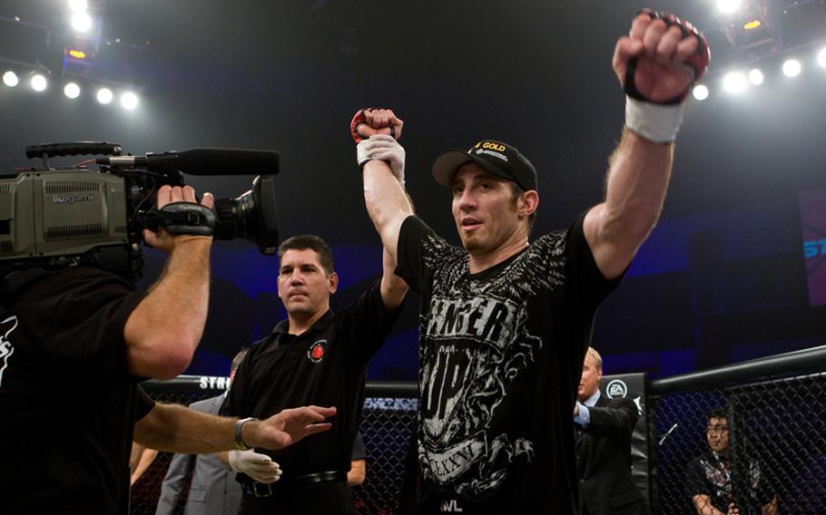 Tim Kennedy celebrates a victory over Zak Cummings in an earlier Mixed Martial Arts bout. He will be fighting Melvin Manhoef on Saturday.