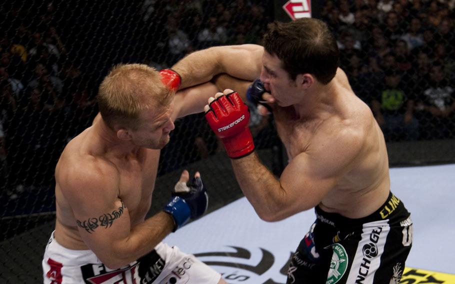 Tim Kennedy exchanges blows with Trevor Prangley, who he later submitted when Kennedy clamped on a rear-naked choke hold.
