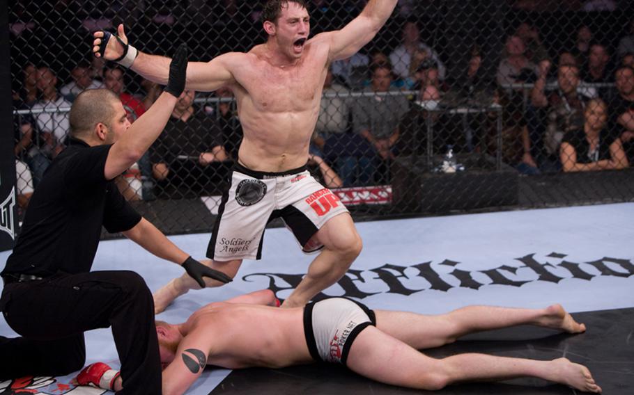 Tim Kennedy displays his victory pose after defeating Zak Cummings. Kennedy, an Army vet currently serving in the National Guard,  has another Mixed Marital Arts bout scheduled for Saturday.