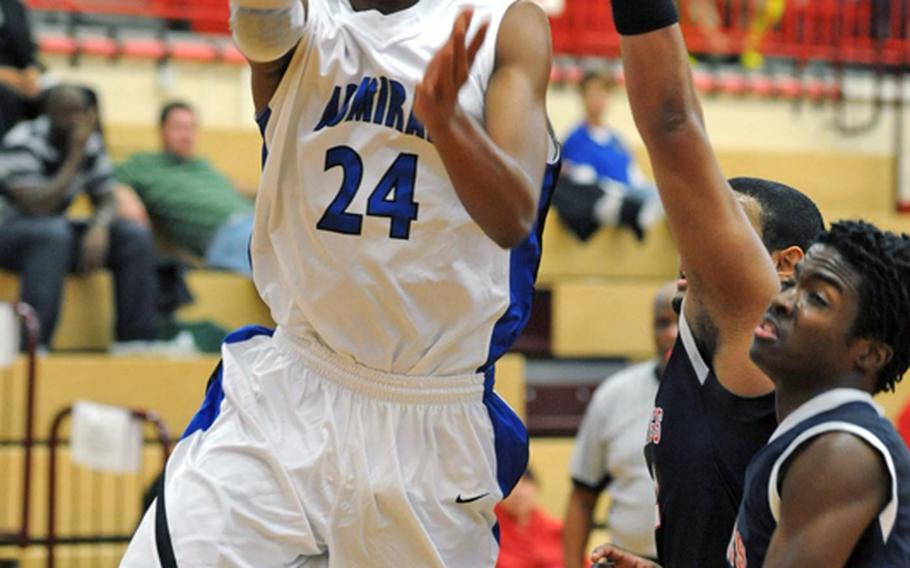 Rota's Tre'von Owens takes it to the hoop against Menwith Hill's Josh Willis and Lawrence Alston during Rota's semifinal victory. Rota went on to win the Division III title game against Sigonella behind 29 points from Owens, who was selected as Stars and Stripes' male athlete of the year in basketball in DODDS Europe.