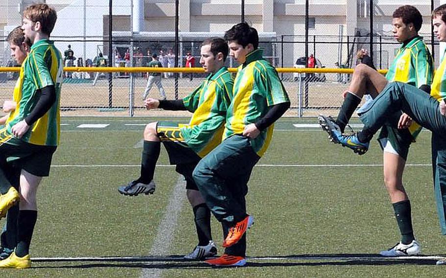 Robert D. Edgren Eagles boys soccer players limber up before Saturday's DODDS Japan season-opening match at Yokosuka Naval Base, Japan. The Eagles won, 4-3, in their first action, practice or otherwise, outdoors.