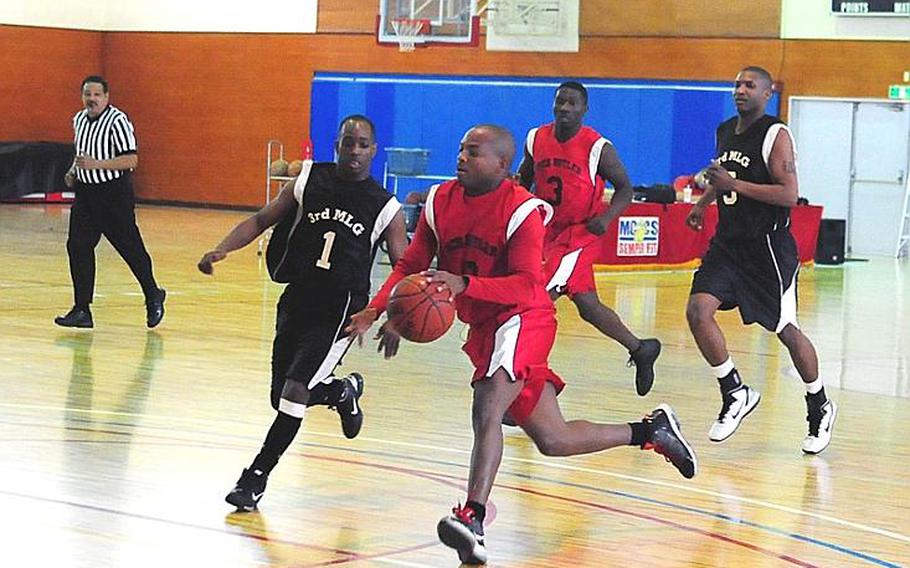 Elonzo Higginson from Marine Corps Base S.D. Butler races up the court in a basketball game against 3rd Marine Logistics Group during the third night of the Marine Corps Far East Regional Basketball Tournament at Marine Corps Air Station Futenma on Wednesday afternoon. 3rd MLG went on to win the game, 67-51.