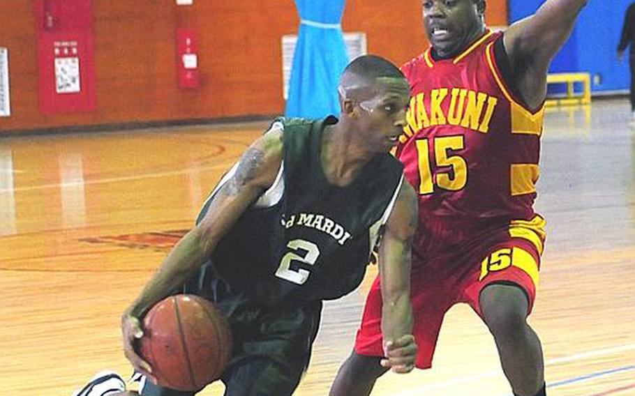 3rd Marine Division's Antoine Phillips dribbles around Marine Corps Air Station Iwakuni's, Rabosky Tanner during the third day of the Marine Corps Far East Regional Basketball Tournament at Marine Corps Air Station Futenma Wednesday afternoon. 3rd Marine Division won the game, 72-61.