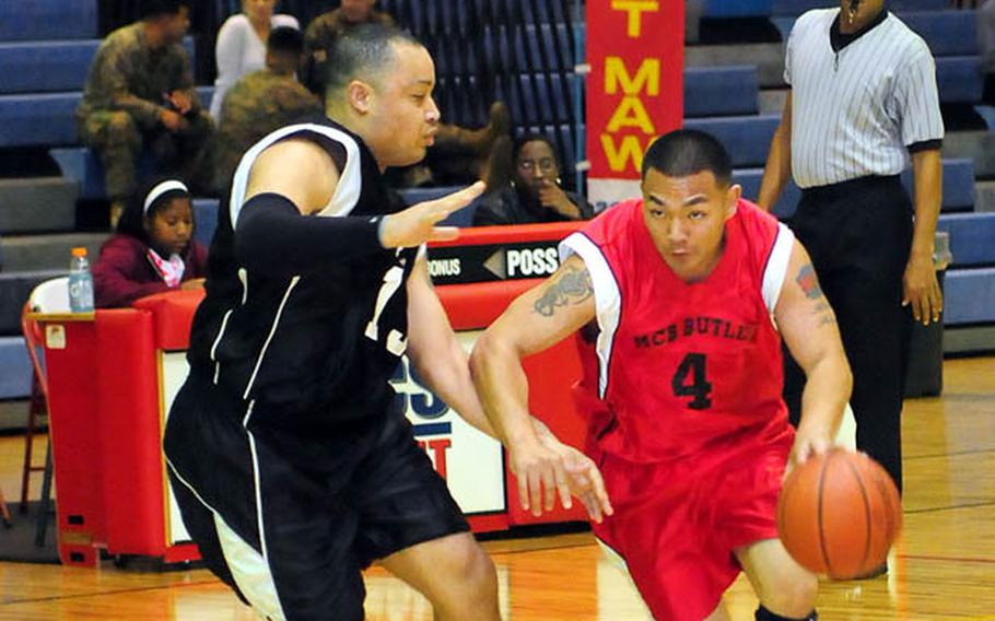 James Meak from Marine Corps Base Camp Butler races up the court and meets some resistance from 3rd Marine Logistics Group's Terrence Terrell during the final minutes of the Far East Regional Basketball Tournament championship game.
