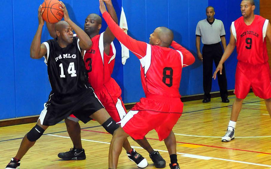 Tournament MVP Marvin Shannon from Marine Logistics Group tries to pass the ball during the finals of the Far East Regional Basketball Tournament Friday at Marine Corps Air Station Futenma. 3rd MLG won the game and the championship, 70-60.