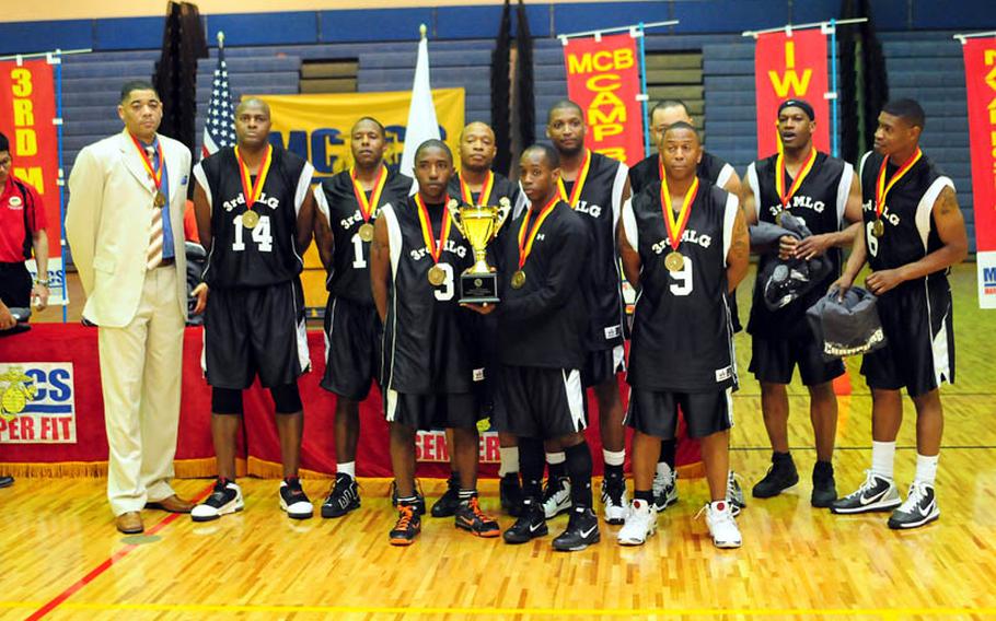 Far East Regional Basketball Tournament Champions, 3rd Marine Logistics Group, stand with their trophy and medals..