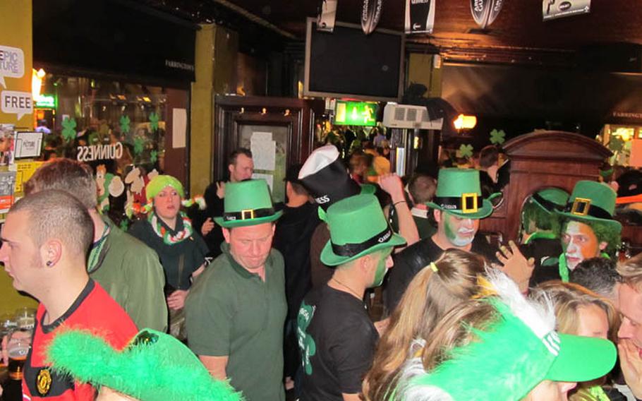 Partiers sport festive hats at Fitzsimons of Temple Bar in the pub district of Dublin on St. Patrick's Day 2010.