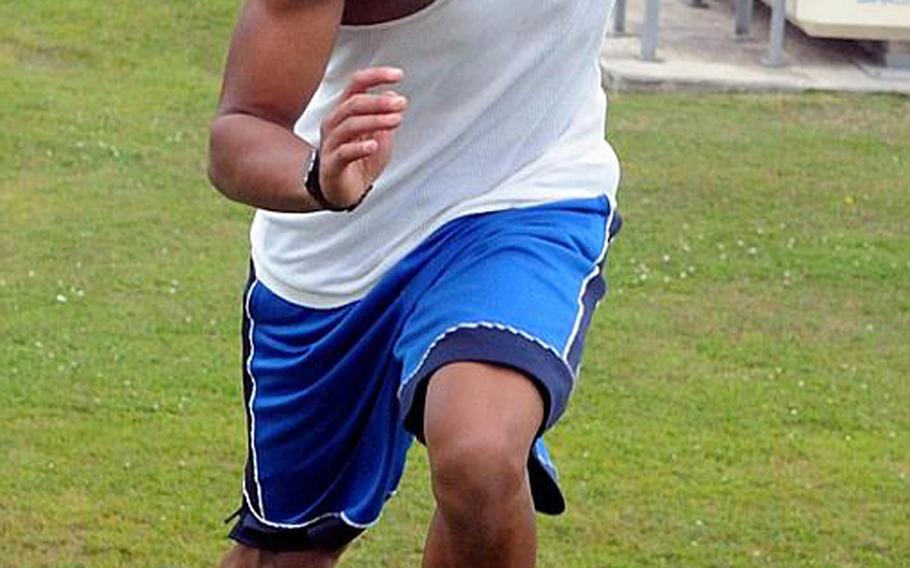 Kubasaki Dragons junior sprinter A.J. Watson makes his way up a steep hill during a conditioning session before Monday's practice at Mike Petty Stadium, Camp Foster, Okinawa.