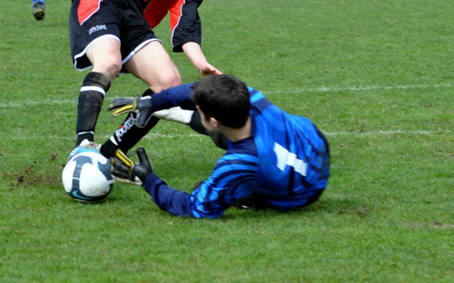 Aviano goalkeeper Corey Webb makes a diving stop to thwart an attempt to score by Pietro Dinmore of American Overseas School of Rome during the opening weekend of spring sports for DODDS-Europe. Webb had a busy day, making 18 saves, as AOSR won, 4-0.