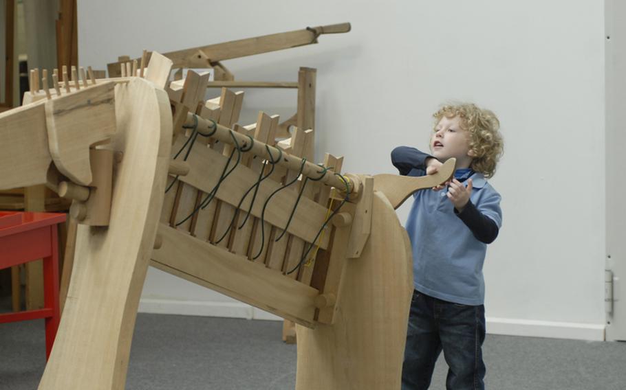 Vincent-Paulus Schlosser, 3, tries to navigate a ball through an elephant-shaped wooden puzzle at the Kinder-Akademie Fulda.