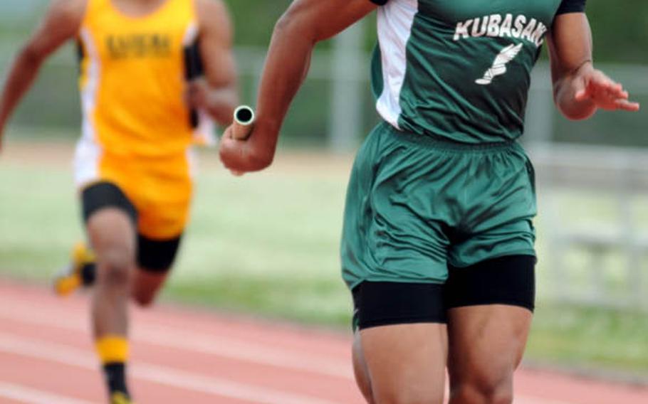 Kubasaki junior sprinter A.J. Watson runs the anchor leg of the boys 400-meter relay and leaves Kadena's Thomas McDonald in his wake during Saturday's Okinawa Activities Council weekly quadrangular track and field meet at Kadena Air Base, Okinawa. Watson and Kubasaki won in 44.55 seconds.