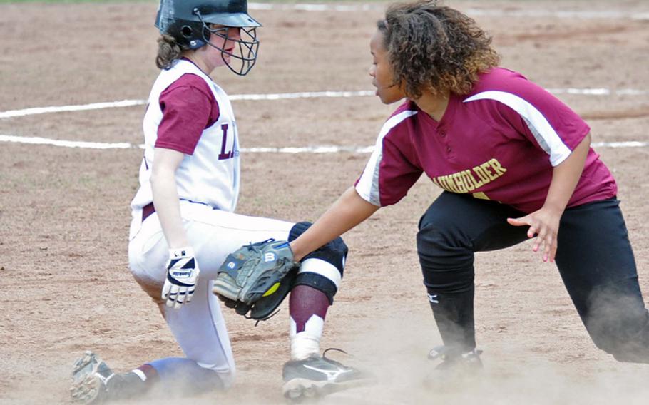 AFNORTH's Brenda Broadwater slips under the tag of Baumholder's Briana Mitchell in the second game of their opening day doubleheader on Saturday. AFNORTH won both games, 16-6 and 19-12.
