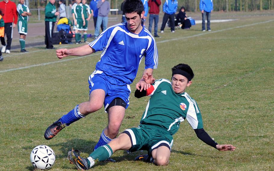 AFNORTH's Robert Marriot, right, tries a sliding tackle in an effort to stop Vasilios Siganos of Brussels in a game at AFNORTH on Saturday. The visiting Brigands came from behind for a 3-2 win.