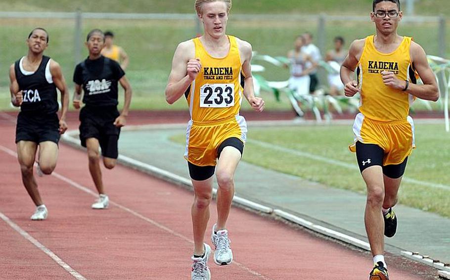 Kadena's Jacob Bishop, middle, and Tomas Sanchez, right, lead the pack down the home stretch of the boys 1,500-meter race during Saturday's Okinawa Relays at Kubasaki High School, Okinawa. Bishop edged Sanchez for first in 4 minutes, 44.08 seconds to 4:44.30.