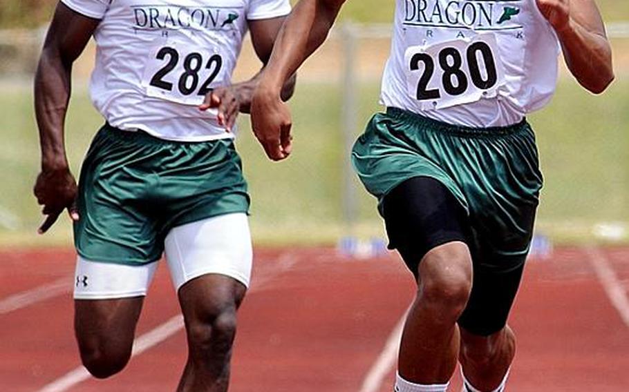 Kubasaki's A.J. Watson, right, leads teammate Jalah Patten through the final yards of the boys 100-meter dash  during Saturday's Okinawa Relays at Kubasaki High School, Okinawa. Watson won the event in 10.27 seconds, .28 better than the 1988 Pacific record set by Tim Gardner of Yokota.